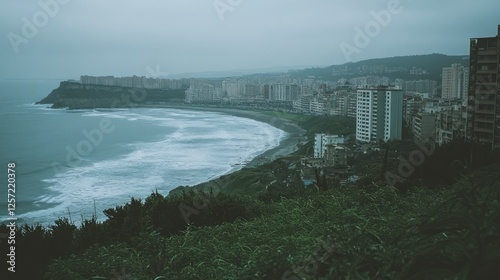 Overcast coastal city view featuring ocean waves and architecture photo