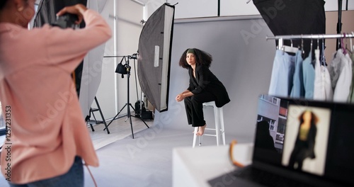 Fashion, woman and photographer with model in studio for magazine photoshoot, media or picture. Camera pose, professional photography or production process on set, creativity and designer advertising
