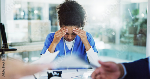 Frustrated woman, nurse and headache with stress in meeting for overworked, anxiety or mistake at hospital. Female person, medical employee or healthcare worker with migraine or fatigue for chaos