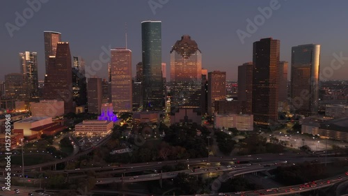 Cinematic aerial shot of Downtown Houston vibrant skyline at dusk, beautifully showcasing stunning architecture, lively city life, and the mesmerizing blend of lights and shadows, Houston, Texas, USA
