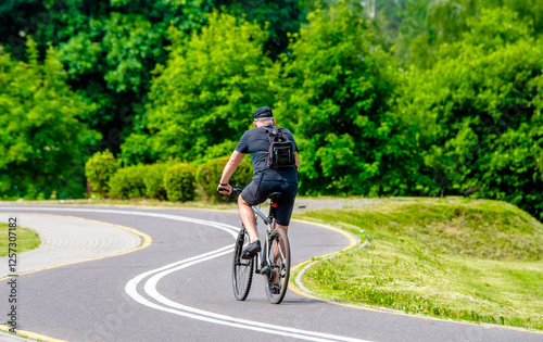 Wallpaper Mural Cyclist ride on the bike path in the city Park
 Torontodigital.ca