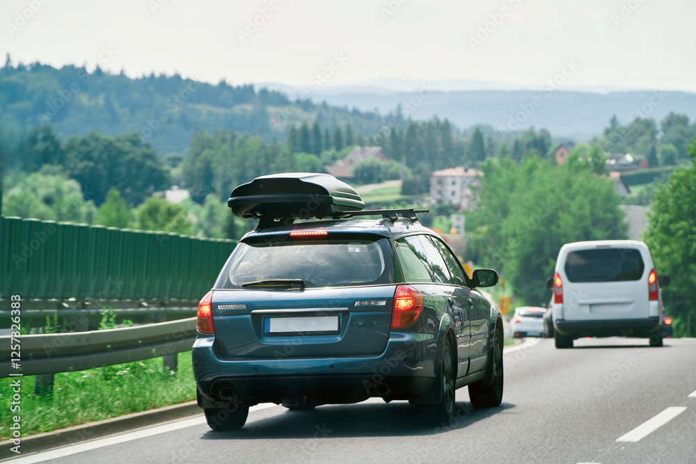 SUV driving on open road with roof storage SUV driving on open road with roof storage