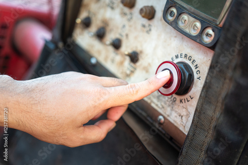 Action of an operator is activate on emergency shutdown button to suddenly stop the pumping machine. Industrial working scene, close-up.
