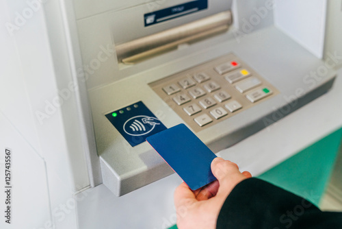 Man tapping card on ATM wireless sensor