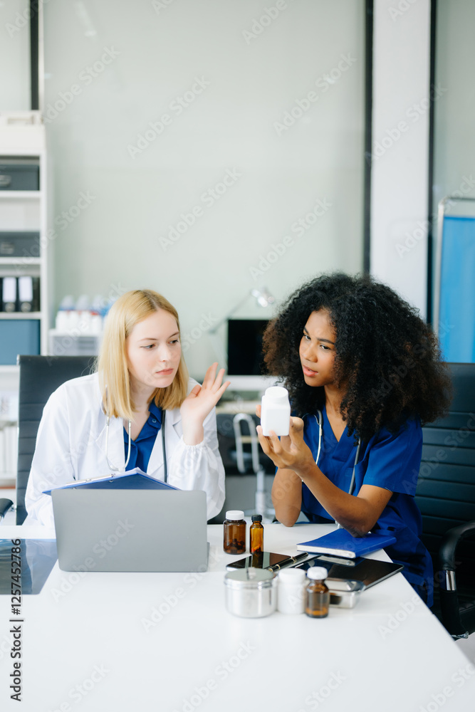 Fototapeta premium Doctors and nurses using laptops and clipboards, showcasing teamwork, modern healthcare.