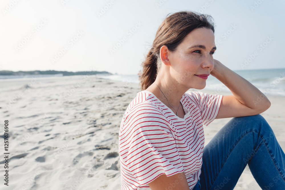 Thoughtful woman with hand in hair at beach Thoughtful woman with hand in hair at beach
