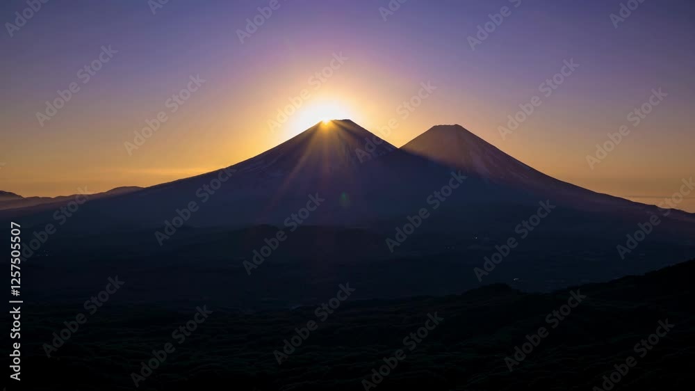 Sunrise over twin volcanic peaks. Sunrise over twin volcanic peaks.