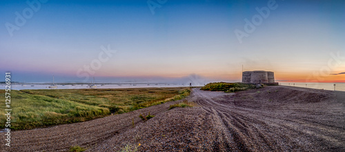 Schilderij op canvas Panorama of Napoleonic Martello tower on shingle beach with small sailing yachts