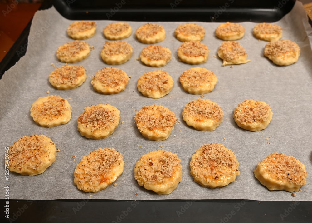 Baking savory cookies with crunchy topping on a baking tray ready for oven