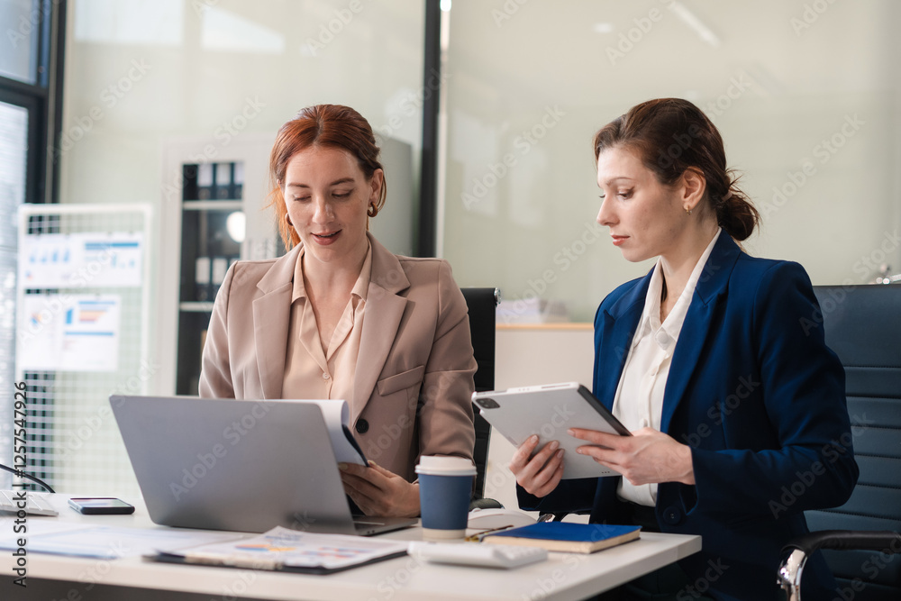 Diverse professionals collaborate on project analysis with financial graphs. Diverse professionals collaborate on project analysis with financial graphs.