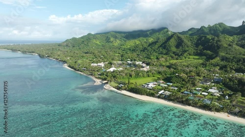 Aerial angled approach establishing of abandoned hotel in Rarotonga Cook Islands, sunny day