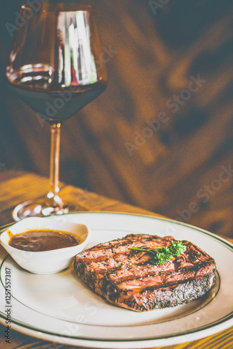 Grilled NZ Angus ribeye Steak served with homemade brown sauce and red wine