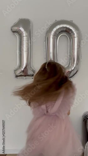 Child girl 10 old years celebrating, celebrating birthday with balloons, exuding happiness and enthusiasm. A birthday party for a happy cute girl. Celebrating the occasion. Happy teenage celebrating B