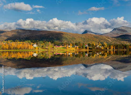 beautiful scenic landscape with mountain and autumnal forest under the sky re...