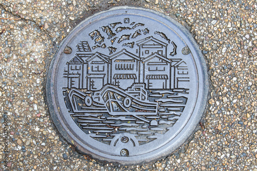Japanese manhole cover on the street of Funaya Japan