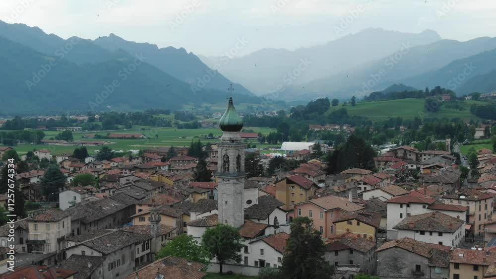 Church of All Saints, Chiesa di tutti i Santi, panoramic view of village and landscape, Rovetta in Italy. Aerial backward Church of All Saints, Chiesa di tutti i Santi, panoramic view of village and landscape, Rovetta in Italy. Aerial backward