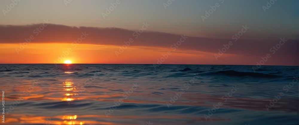 Obraz premium Exquisite closeup of a calm sea reflecting colorful sunsets inviting blissful moments spent lounging under the fading light
