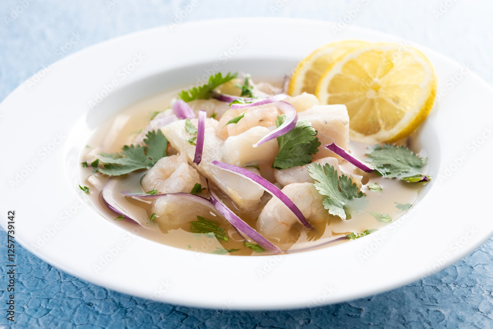 Traditional Peruvian ceviche sea bass fillet on blue background Traditional Peruvian ceviche sea bass fillet on blue background
