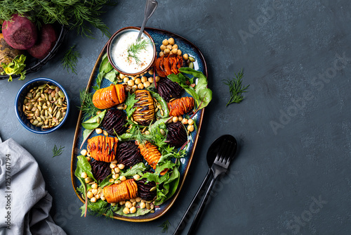 Root vegetables roast until soft in the center and crispy with chickpeas, pumpkin seeds
