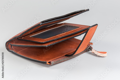 Unbuttoned partly open classic brown-orange leather wallet, side view photo