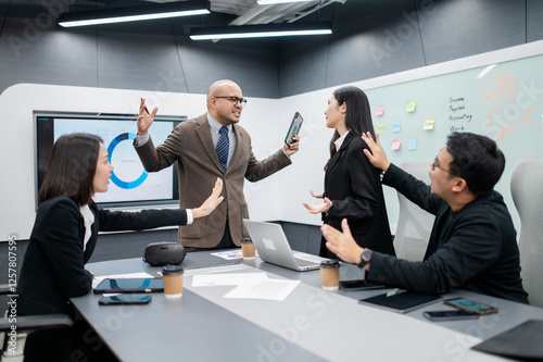 Male software developer meeting in modern office with stressed employees, documents, laptops, sales planning, digital marketing and growth strategies, analysis with colorful charts and graphs.