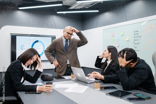 Male software developer meeting in modern office with stressed employees, documents, laptops, sales planning, digital marketing and growth strategies, analysis with colorful charts and graphs.