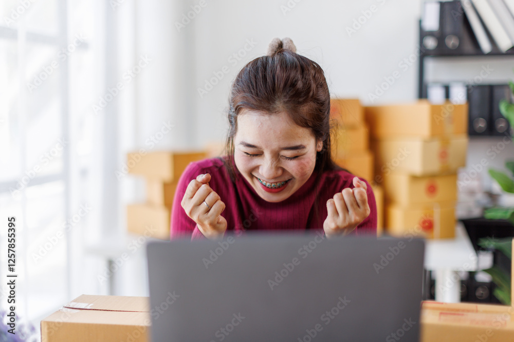Happy excited asian woman working at home with her laptop,she’s online seller. Happy excited asian woman working at home with her laptop,she’s online seller.