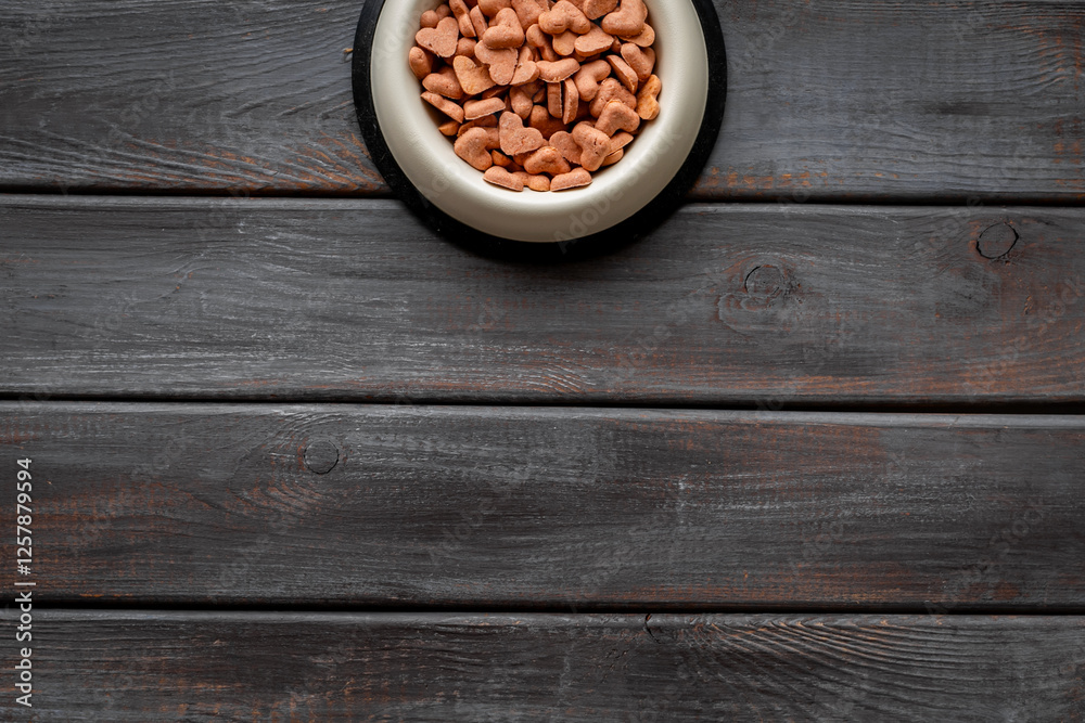 Food and treats for pets - biscuits in a shape of heart in a bowl Food and treats for pets - biscuits in a shape of heart in a bowl