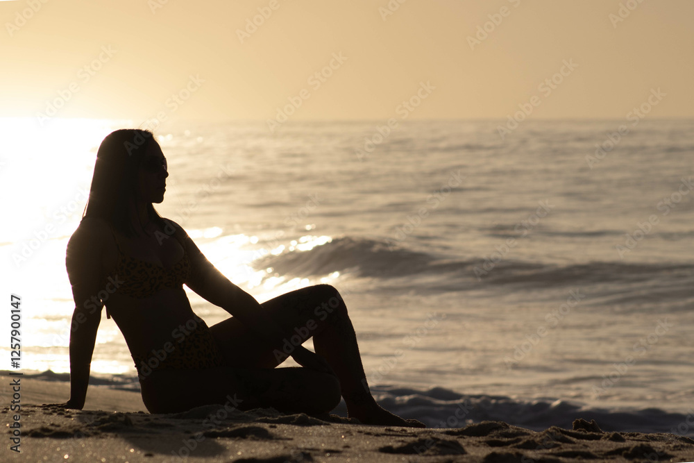 Fototapeta premium Girl silhouette on beach at dawn 3.1