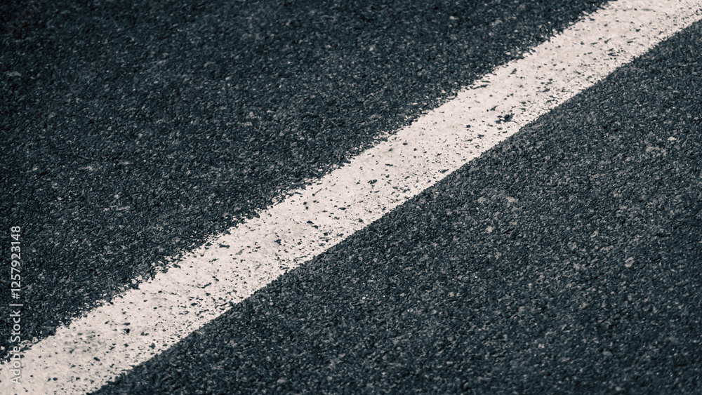 Obraz premium white streak of paint on gray asphalt