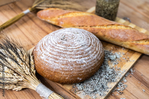 Freshly baked bread with dietary supplements on the table. Still life of bread, baguette, ears of corn, deer moss