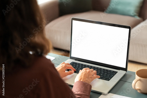 Over shoulder view of female freelancer business woman working remotely, looking at white blank mockup laptop pc screen for advertising. Student doing ai search online for it work or studying at home