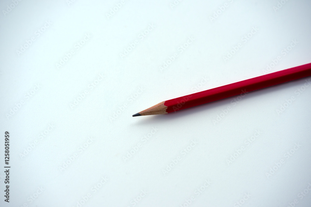 Close-up of red wooden pencil with point against white background. Photo taken February 11th, 2025, Zurich, Switzerland.