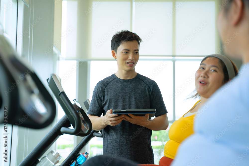 Obraz premium Plus size women workout at fitness center.