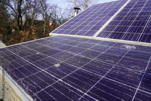 Broken solar panel with cracks and a hole from a bullet or shrapnel