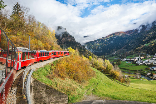 Red swiss train, Bernina Express, in Swiss Alps. Tirano to St. Moritz. Switzerland