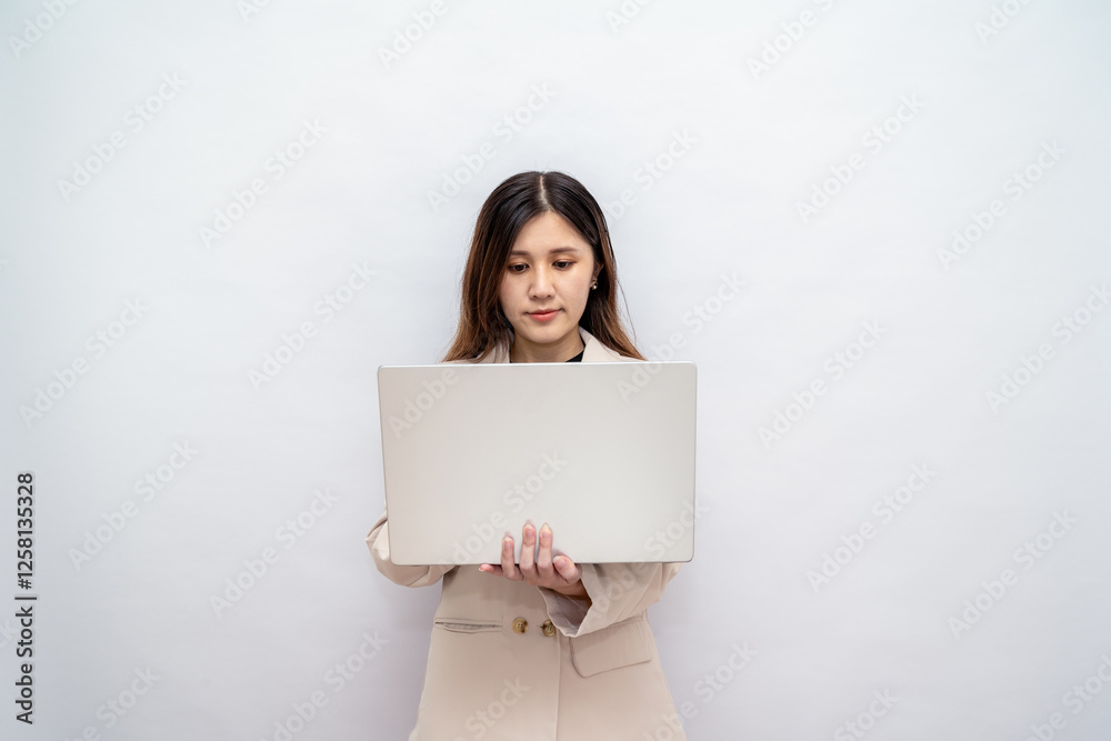 Confident Businesswoman Holding a Laptop in a Professional Setting,Corporate Lady Using a Laptop for Business and Technology Confident Businesswoman Holding a Laptop in a Professional Setting,Corporate Lady Using a Laptop for Business and Technology