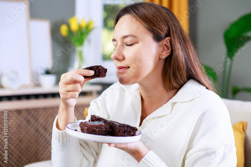 Young woman eating chocolate cake