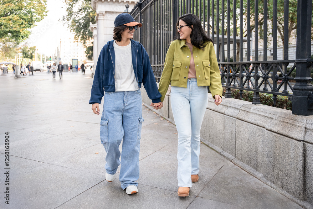 Happy lesbian couple enjoying a walk together in the city Happy lesbian couple enjoying a walk together in the city