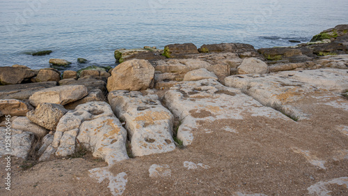 The rocky coast of the Caspian Sea. Cliffs on the seashore. Landscape with a view of the stones on the shore of the Caspian Sea in Dagestan.