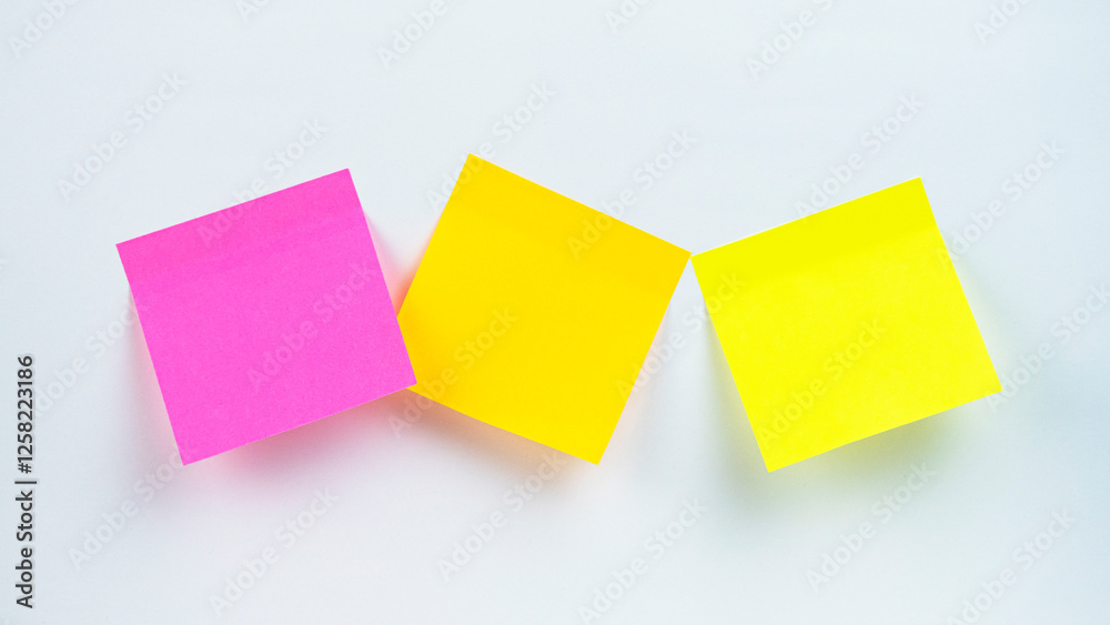 Fototapeta premium Colorful sticky notes arranged on a white surface