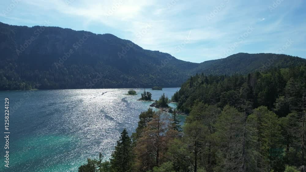 Breathtaking aerial view of a serene lake surrounded by mountains and lush forests in nature in Germany Bavarian region Breathtaking aerial view of a serene lake surrounded by mountains and lush forests in nature in Germany Bavarian region
