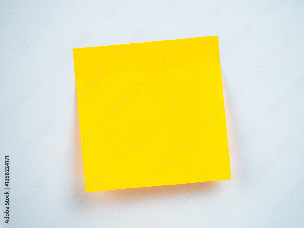 Bright yellow sticky note on a plain background Bright yellow sticky note on a plain background