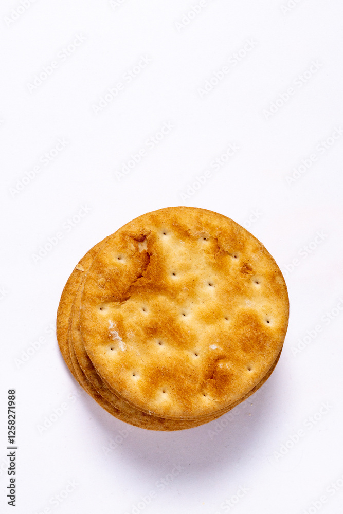 Golden light crispy and flacky butter puff biscuits on white background. Top view. Copy space. Golden light crispy and flacky butter puff biscuits on white background. Top view. Copy space.