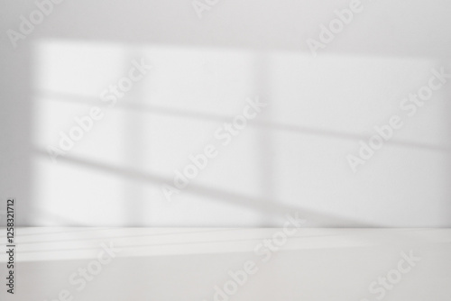 Fototapeta Naklejka Na Ścianę i Meble -  Sunlight coming through the window on the white wall background with copy space