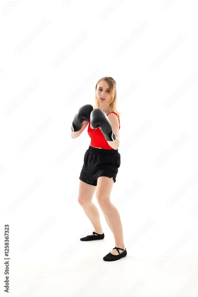 Young woman practicing boxing techniques in a studio setting for fitness and skill development Young woman practicing boxing techniques in a studio setting for fitness and skill development