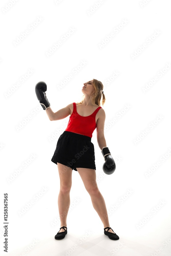 Boxer practices technique in a training studio with a minimalistic background Boxer practices technique in a training studio with a minimalistic background