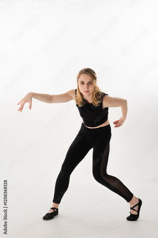 Young dancer performs contemporary dance moves in a minimalist studio setting with bright background Young dancer performs contemporary dance moves in a minimalist studio setting with bright background