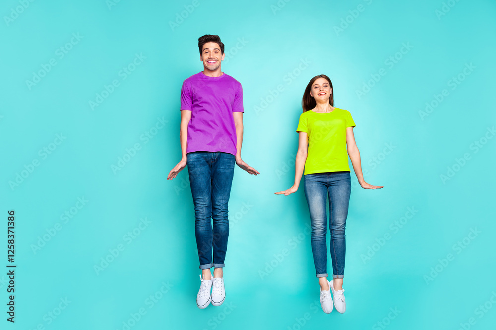 Full length body size view of nice attractive lovely cute funky cheerful cheery modest couple jumping in air having fun time isolated on bright vivid shine vibrant green turquoise background Full length body size view of nice attractive lovely cute funky cheerful cheery modest couple jumping in air having fun time isolated on bright vivid shine vibrant green turquoise background