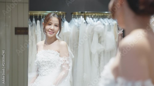 Close up beauty young adult happy woman asia people prepare lace clothes for tied knot wedding life event party get dressed up wear white dress try on fitting room modern luxury bridal store.